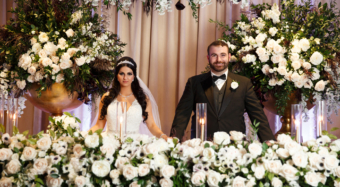 sweetheart table covered in white flowers at the sofia banquet hall noor