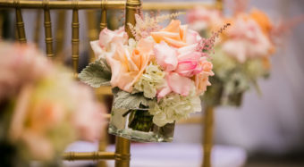 close up of gold chairs and floral details at a terrace wedding ceremony